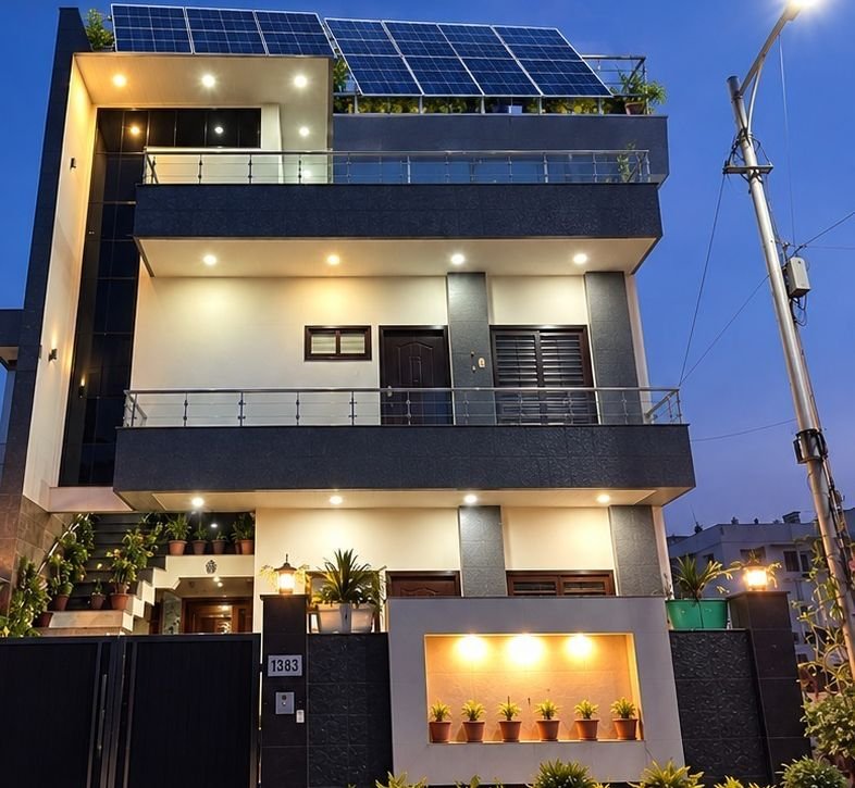 Three-storey home with rooftop solar panels at dusk